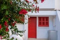 White house with red door, window and flowers Royalty Free Stock Photo