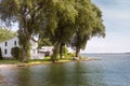 White house on a shaded lake shoreline Royalty Free Stock Photo