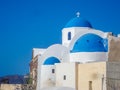 White houses, churches and blue domes in Oia village Royalty Free Stock Photo