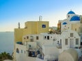 White houses, churches and blue domes in Oia village Royalty Free Stock Photo