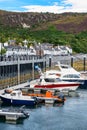 White houses on the coast and boats docked in the port of the city of Ullapool, Scotland. Royalty Free Stock Photo