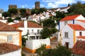 White houses, cobblestone streets and castle walls in Obidos, Portugal
