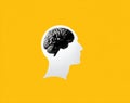 White human head silhouette with realistic black brain inside on vibrant yellow background symbolizing intelligence and thought Royalty Free Stock Photo