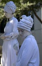 White human sculptures wearing turbans profile