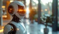 White humanoid robot head with glowing orange eyes and internal lights standing in modern blurred office or lobby environment Royalty Free Stock Photo