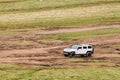 White Hummer H2 SUV Car On Off Road In Spring Mountains Landscape In Georgia. Landscape Of Gorge At Spring Season Royalty Free Stock Photo