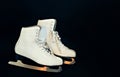 White ice skates for figure skating on a black background Royalty Free Stock Photo