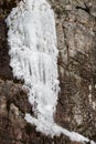 White icicles coming down from a mountain, vertical image