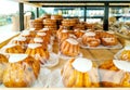 White icing cupcake, various cookies, baked goods and puff pastry serving for sell on shelfs in supermarket bakery Royalty Free Stock Photo