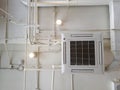White Industrial air conditioner cooling pipe with plumbing at ceiling. Ventilation system ceiling air duct