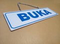 The white information board read BUKA. BUKA means OPEN Royalty Free Stock Photo