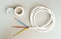 White insulating tape and three-core cable on a gray background