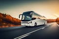 white intercity bus rides on highway, sunset Royalty Free Stock Photo