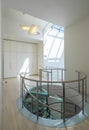 White interior of luxury private house. Glass and metal spiral staircase. Royalty Free Stock Photo