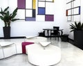 White interior of waiting room for guests. White walls, black table, white seats