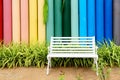 White iron bench and multicolor concrete fence