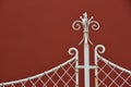 White iron fence details with red wall background Royalty Free Stock Photo