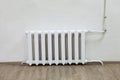 White iron radiator central heating on wall in room