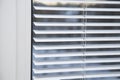 White iron shutters on the window. Installation of blinds Royalty Free Stock Photo