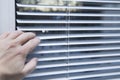 White iron shutters on the window. Installation of blinds Royalty Free Stock Photo