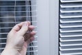 White iron shutters on the window. Installation of blinds Royalty Free Stock Photo