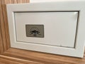 White iron small safe in the hotel room for storing valuables and money Royalty Free Stock Photo