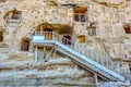 White iron stairs leading to one of the naturally cool, stone carved warehouses in Ermenek, Turkey, an ancient tradition
