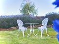 White iron table and chairs in the Lavender garden with blue sky background. Royalty Free Stock Photo