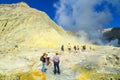 White Island, New Zealand. Tourists walking toward the crater lake