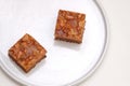 Blurred two pieces of toffee cake on white plate Royalty Free Stock Photo