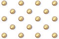 On a white isolated background a pattern of round candies in a gold package.