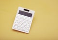 White isolated calculator on yellow banner finance and expenses concept