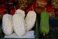 White bitter gourds with ridged texture in basket at traditional market stall Royalty Free Stock Photo