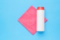 A white jar with cleaning agent and a red cleaning cloth on a blue background. Cleaning kit Royalty Free Stock Photo