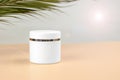 White jar of moisturizer or sunscreen on a colored background. Blank for advertising skin cream or sunscreen Royalty Free Stock Photo