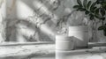 White Jars on Marble Surface with Sun Rays and Greenery Royalty Free Stock Photo