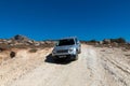 A white Jeep Renegade is parked on a dirt road. All wheel drive.