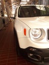 White Jeep Renegade parked in a large parking lot