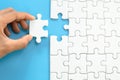 White jigsaw in the hands, The correct solution. Teamwork, Solving and completing the task. Last piece of jigsaw puzzle. Royalty Free Stock Photo