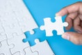 White jigsaw in the hands, The correct solution. Teamwork, Solving and completing the task. Last piece of jigsaw puzzle. Royalty Free Stock Photo