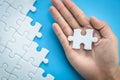 White jigsaw in the hands of humans, The correct solution. Teamwork, Solving and completing the task. Last piece of jigsaw puzzle Royalty Free Stock Photo