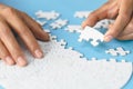 White jigsaw in the hands of humans, The correct solution. Teamwork, Solving and completing the task. Last piece of jigsaw puzzle Royalty Free Stock Photo