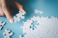 White jigsaw in the hands of humans, The correct solution. Teamwork, Solving and completing the task. Last piece of jigsaw puzzle Royalty Free Stock Photo