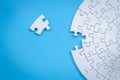 White jigsaw pieces on a blue background, Copy space, Concept image of unfinished task.  missing jigsaw puzzle pieces and business Royalty Free Stock Photo