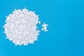 White jigsaw pieces on a blue background, Copy space, Jigsaw puzzle with missing piece. Completing final task Royalty Free Stock Photo