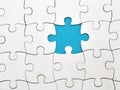 White jigsaw puzzle on blue background, top angle view Royalty Free Stock Photo