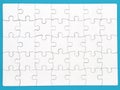 White jigsaw puzzle on blue background, top angle view Royalty Free Stock Photo