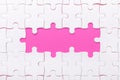 White jigsaw puzzle with empty space for text and pink background Royalty Free Stock Photo