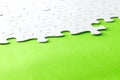 White jigsaw puzzle on green background Royalty Free Stock Photo