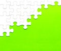 White jigsaw puzzle on green background Royalty Free Stock Photo